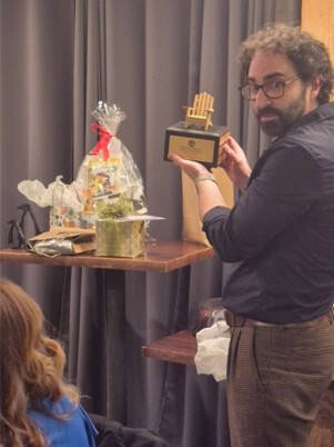 Chris Kurby holding up chair plaque